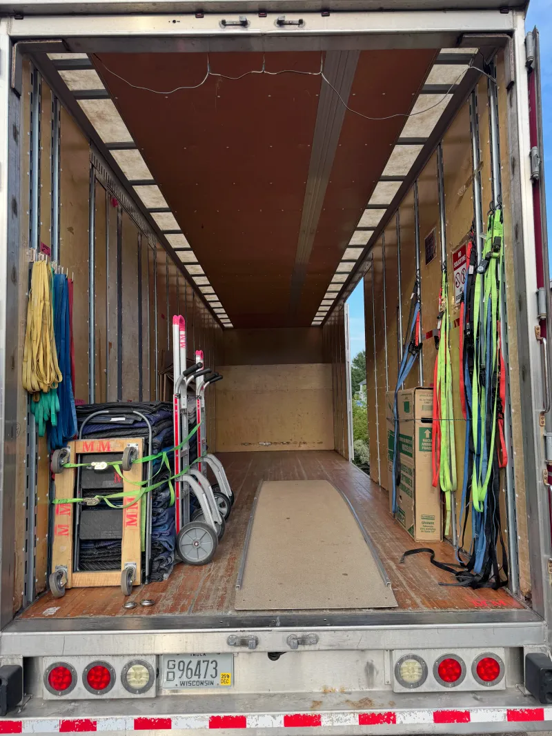 The clean, padded interior of an Elite Movers truck
